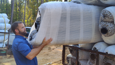 Ben Rabon holding EZ Flow Drainage System