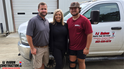 Family photo of Ben, Ashleigh, and Will Rabon in front of FJ Rabon truck and business