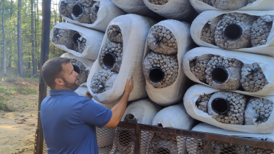 Ben Rabon, owner of FJ Rabon Construction, unloading EZ Flow Drainage System at a job site