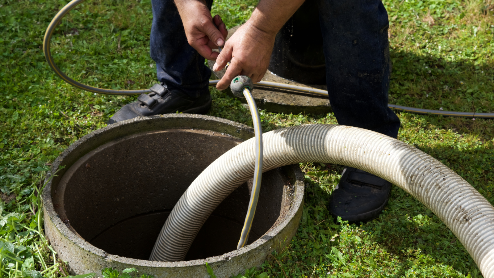 FJ-Rabon-Septic-Cleaning man pumping septic tank with hose